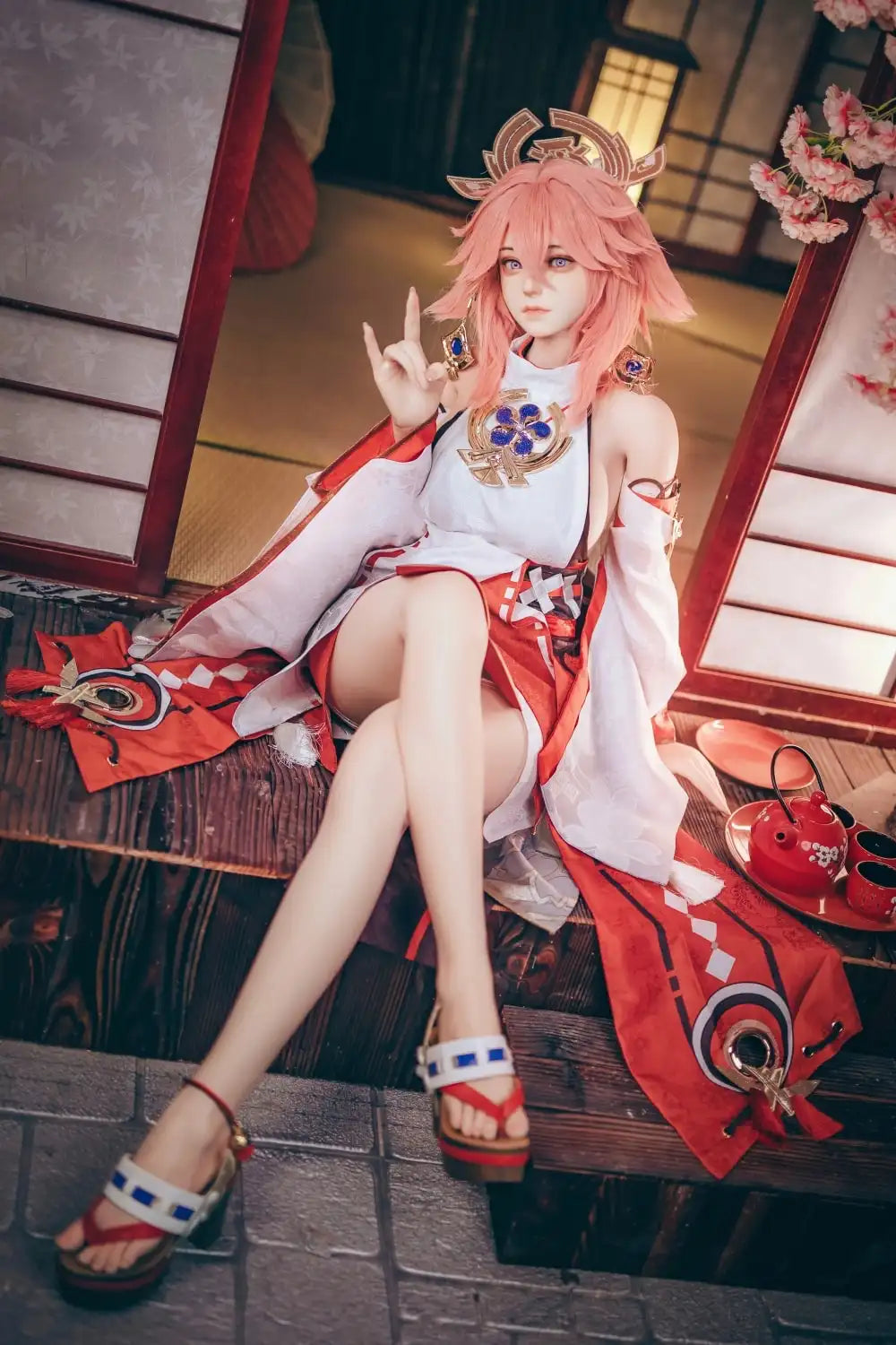  Yae Miko Genshin Impact cosplay sex doll, pink hair, sensual miko outfit, tatami room red cup – anime cosplay lifesize doll by TopLoveDoll,  red bell anklet, wooden geta sandals, Genshin Impact sex doll, sitting on the stairs, legs crossed, holding a J-style red cup, high-angle bust shot