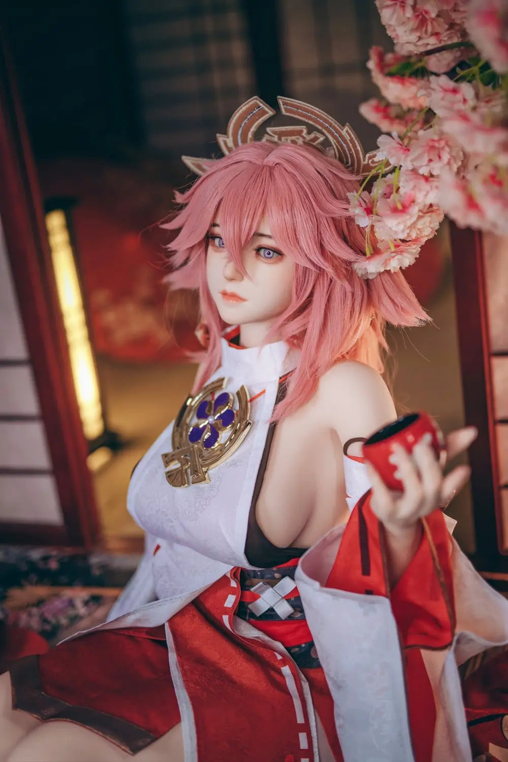  Yae Miko Genshin Impact cosplay sex doll, pink hair, sensual miko outfit, tatami room red cup – anime cosplay lifesize doll by TopLoveDoll,  red bell anklet, wooden geta sandals, Genshin Impact sex doll, sitting on the stairs, legs crossed, holding a J-style red cup, bust shot, purple eyes