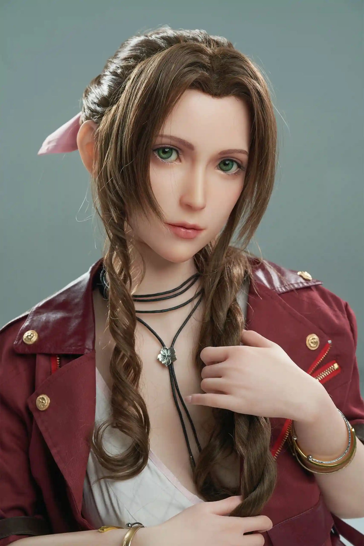 Seyo, brown wavy twin braids, pink hair bow, burgundy leather jacket, white deep-V slip dress, green eyes, layered leather string choker, sit sideways on the floor, grey studio background – Tifa Lockhart cosplay sex doll by TopLoveDoll