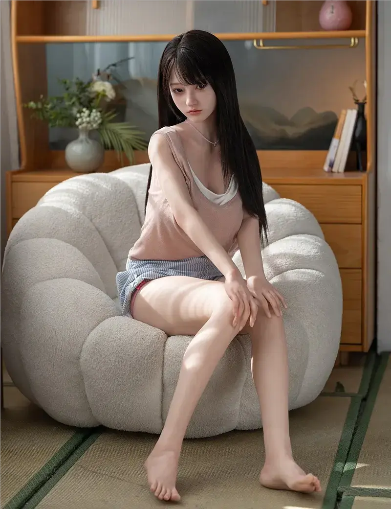 June, long straigh black hair, light coral linen camisole layered over a white tank top, blue strip shorts, petite and exquisite choker necklace, sitting in a greyish white couch, sulky vibes, eye-level bust shot –asian girl next door sex doll by TopLoveDoll
