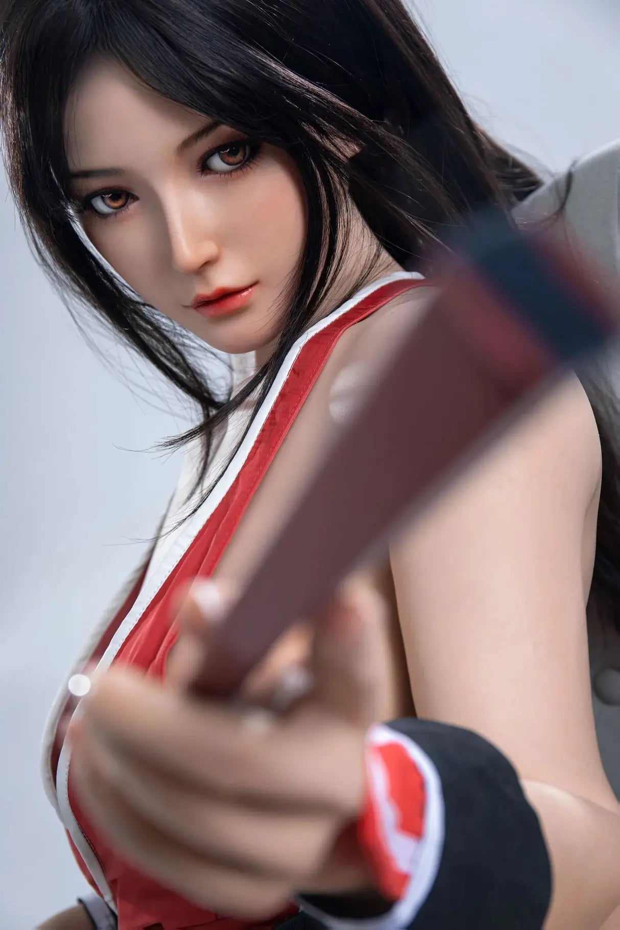 Aileen, long black hair, high ponytail with half-down hair, red Mai Shiranui signature kunoichi costume, holding her signature weapon(the fan), sex AF, standing and pointing her fan to the camera, full white studio background, eye-level side view, blurry gorgeous curves, close-up – cosplay sex doll by TopLoveDoll 