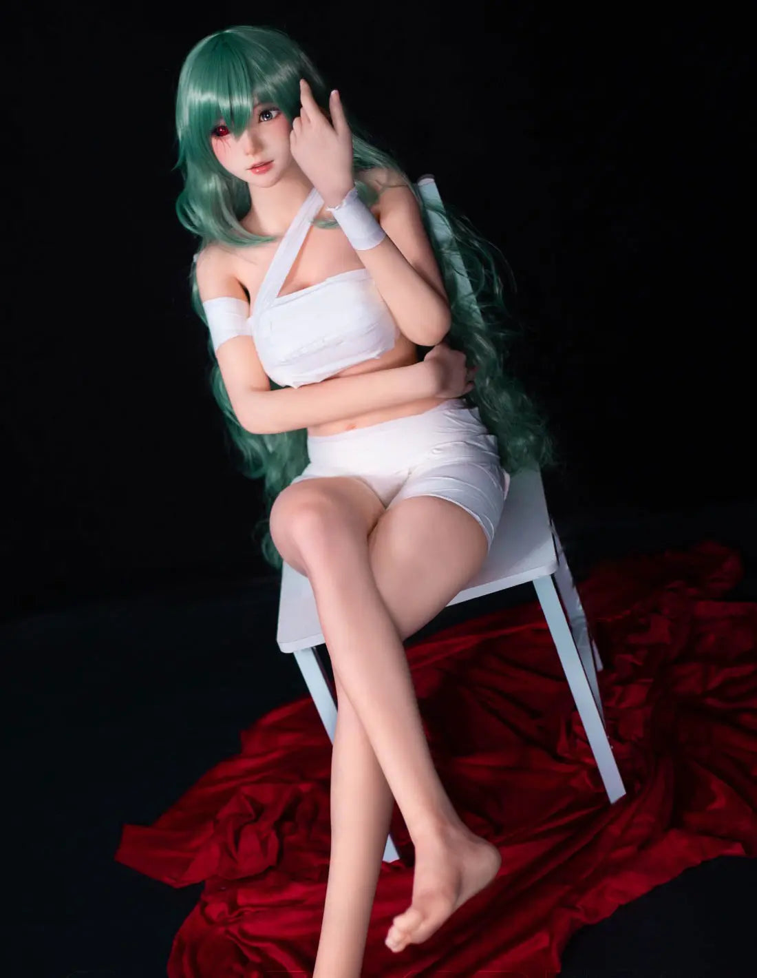 Alayah, green long wavy hair, white crop top, white shorts, dark studio lighting, Takatsuki Sen Eto Tokyo Ghoul, half-human half-ghoul, standing on a red carpet, with a steel doll stand held between the thighs, one red & black ghoul eye, one green human eye, sitting on a white chair – anime cosplay fantasy sex doll by TopLoveDoll