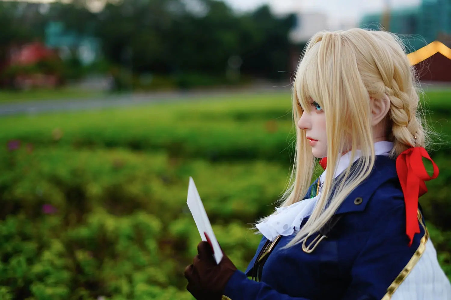 Aliana, golden straight long hair, blue eyes, navy Auto Memory Doll uniform, white apron, black leather boots, outdoor, standing, holding an envelop, brown gloves, holding a brown leather suitcase, eye-level shot, side view, look away, doing the salute gesture, horizontal profile – Violet Evergarden cosplay anime sex doll by TopLoveDoll