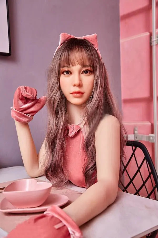 Amelia long wavy brown hair pink crop top pink mini skirt Y2K sweetgirl sitting in pink room soft Asian companion, sitting on a pink chair wearing pink lingerie set, sitting at the dinner table – girl-next-door sex doll by TopLoveDoll