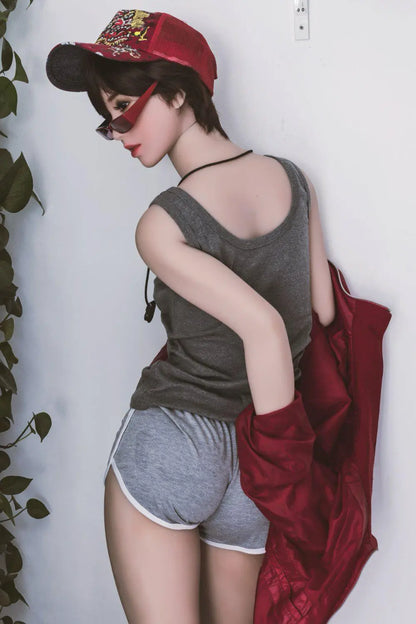 Amira short dark brown hair red lip grey tank denim shorts red jacket tomboy feminine contrast pose, standing against the wall next to the plants shelf, baseball hat, red sunglasses, taking off the jacket back view– girl-next-door companion sex doll by TopLoveDoll