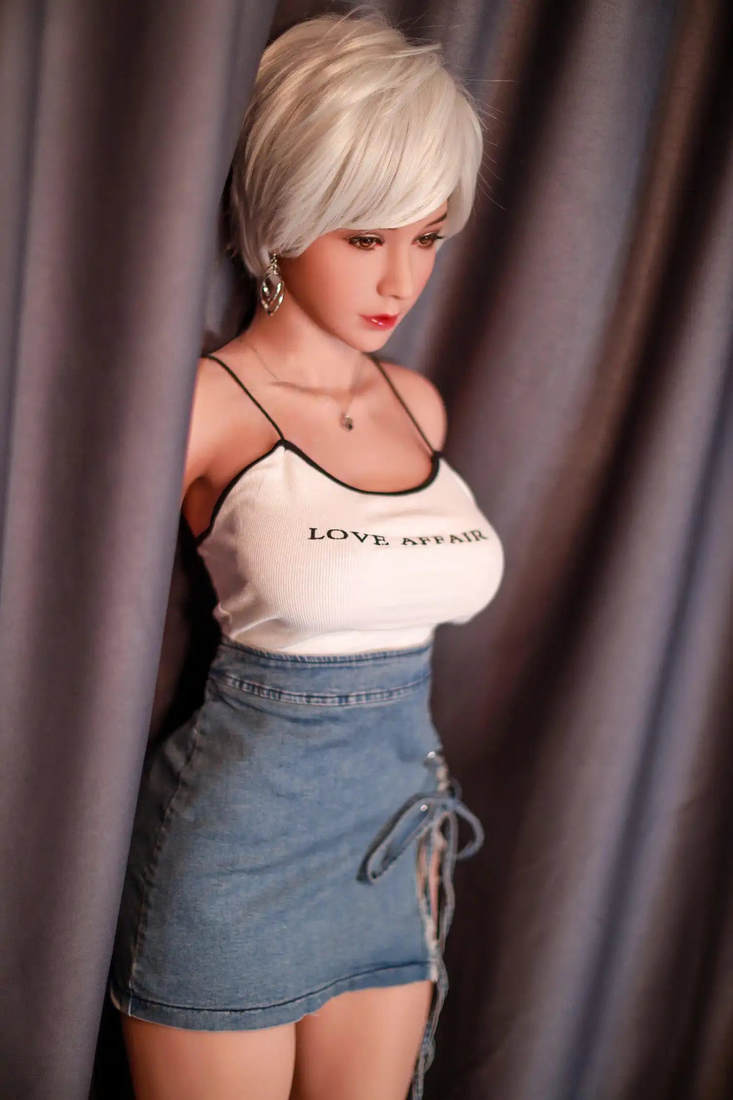 Anahi short platinum blonde hair tan skin white fitted tank denim micro skirt bold Shibuya street style pose, standing in front of the hotel curtain, side view – Asian blonde pornstar sex doll by TopLoveDoll