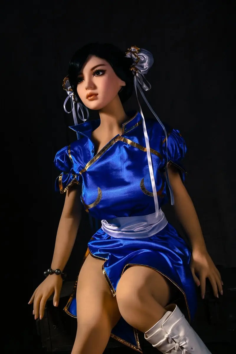 Aubriella Street Fighter Chun-Li cosplay sex doll in blue qipao and white leather boots on a black background - iconic blue qipao fighter fantasy by TopLoveDoll