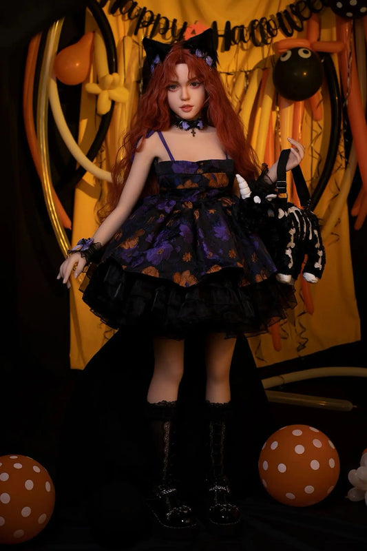 Amora Halloween witch sex doll full body standing, black lace dress, cat ears, auburn ginger waves, Halloween pumpkin backdrop, lifelike adult doll by TopLoveDoll