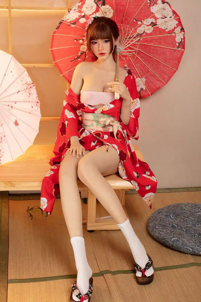 Raina sweet Asian face red floral kimono yukata parted open full figure tatami setting red oil-paper umbrella cherry blossom print, sitting next a pink Asian style umbrella, holding a red peach blosom umbrella– Japanese geisha cosplay sex doll by TopLoveDoll