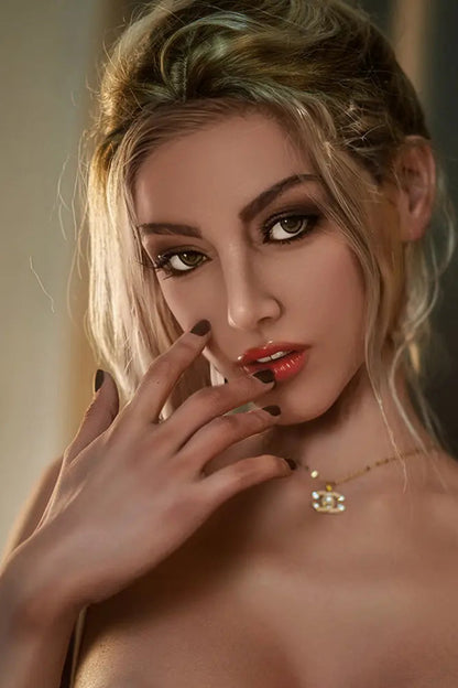 Woman with blonde hair and red lipstick posing with hand near face